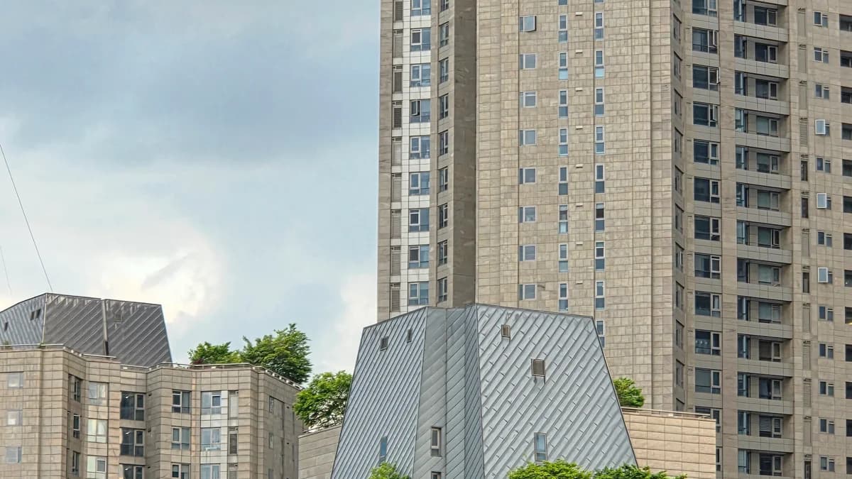 Architectural view of contemporary high-rise buildings in Seoul, showcasing urban design with lush greenery on rooftops.
